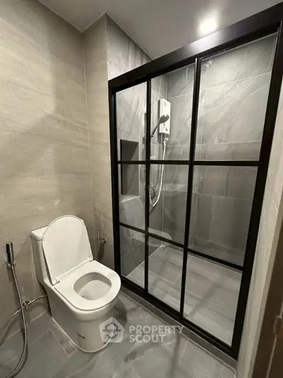 Modern bathroom with sleek shower enclosure and contemporary toilet design.