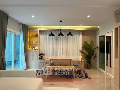 Modern living room with elegant dining area and stylish lighting