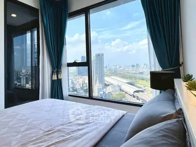 Modern bedroom with panoramic city view and large windows