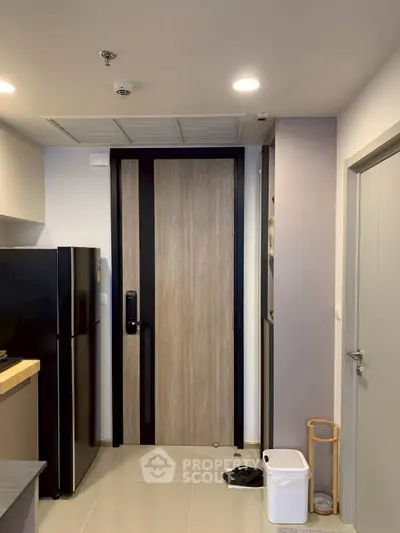 Modern apartment entrance with sleek kitchen and stylish door design
