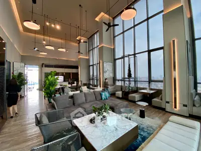 Luxurious high-rise living room with floor-to-ceiling windows and modern decor.