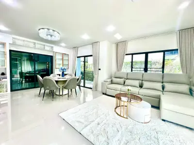 Luxurious open-plan living room with elegant dining area and modern decor.