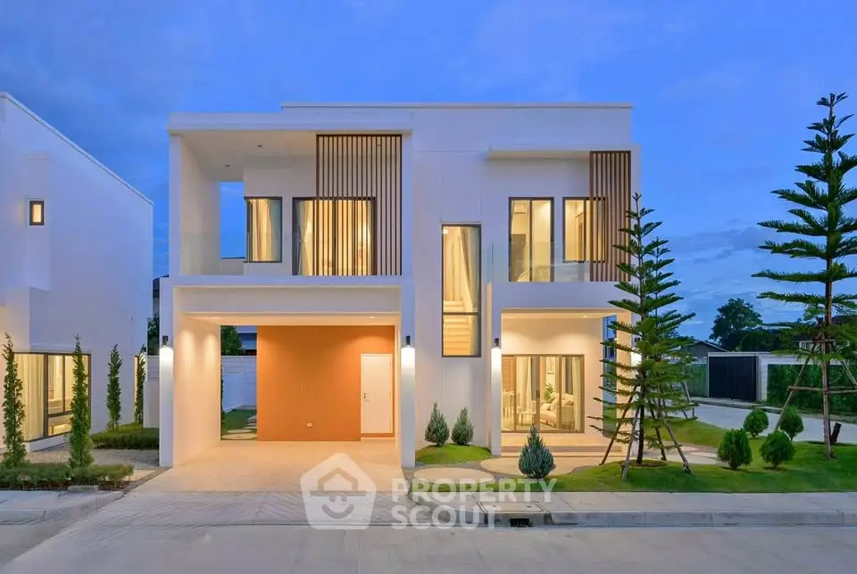 Modern two-story house with sleek design and landscaped garden