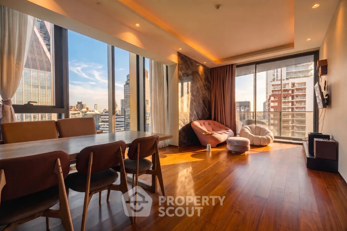Luxurious living room with panoramic city views and elegant wooden flooring.
