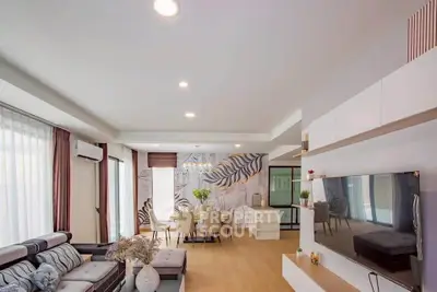 Spacious modern living room with stylish decor and open layout, perfect for entertaining.