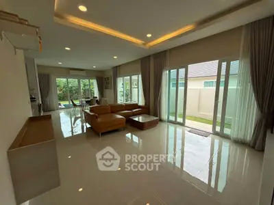 Spacious modern living room with large windows and garden view