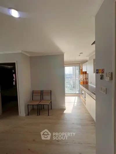 Bright kitchen with open layout and balcony view in modern apartment