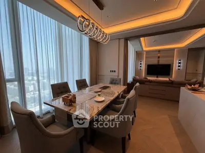 Luxurious dining and living area with elegant lighting and city view