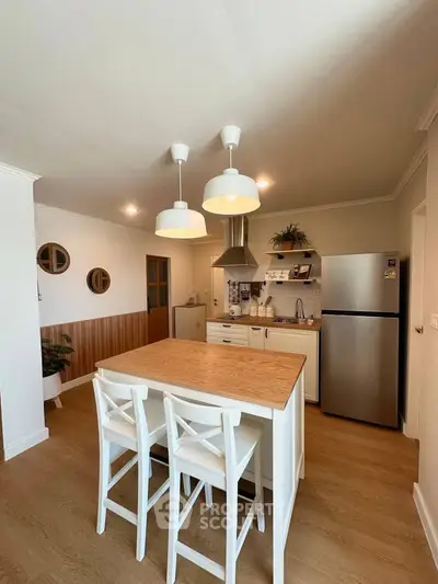 Charming kitchen with island, modern appliances, and cozy dining area in a stylish home.