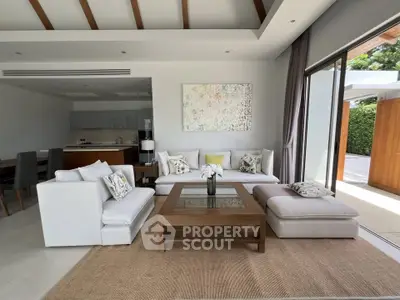 Luxurious open-plan living room with modern decor and natural light, perfect for relaxation and entertaining.