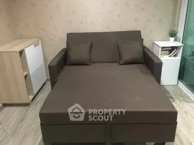 Cozy living room with a stylish brown sofa bed and modern decor