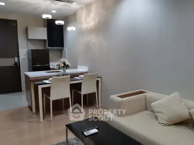 Modern open-layout living room with cozy dining area and stylish lighting