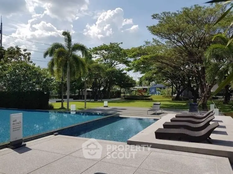 Luxurious outdoor pool area with lush greenery and modern lounge chairs
