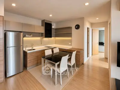 Modern kitchen with sleek design, featuring stainless steel appliances and a stylish dining area.