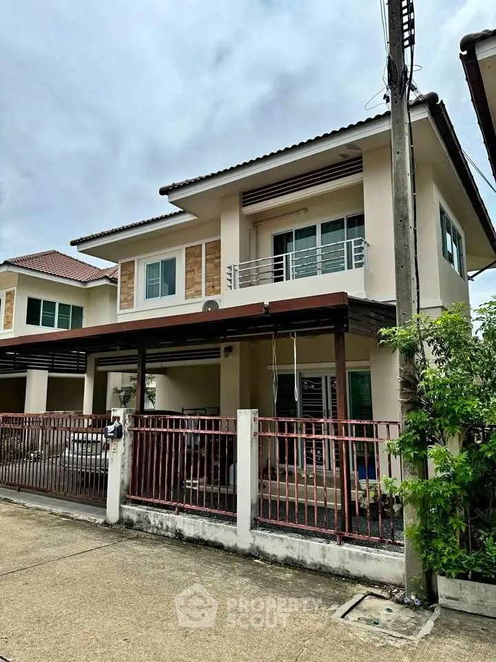 Charming two-story house with modern design and spacious balcony in a serene neighborhood.