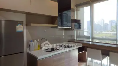 Modern kitchen with sleek appliances and city view, perfect for urban living.