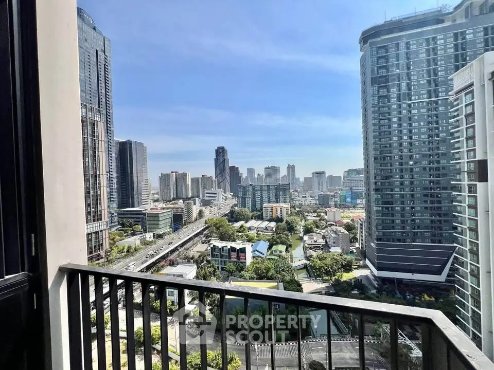 Stunning cityscape view from a high-rise balcony, showcasing modern skyscrapers and vibrant urban life.