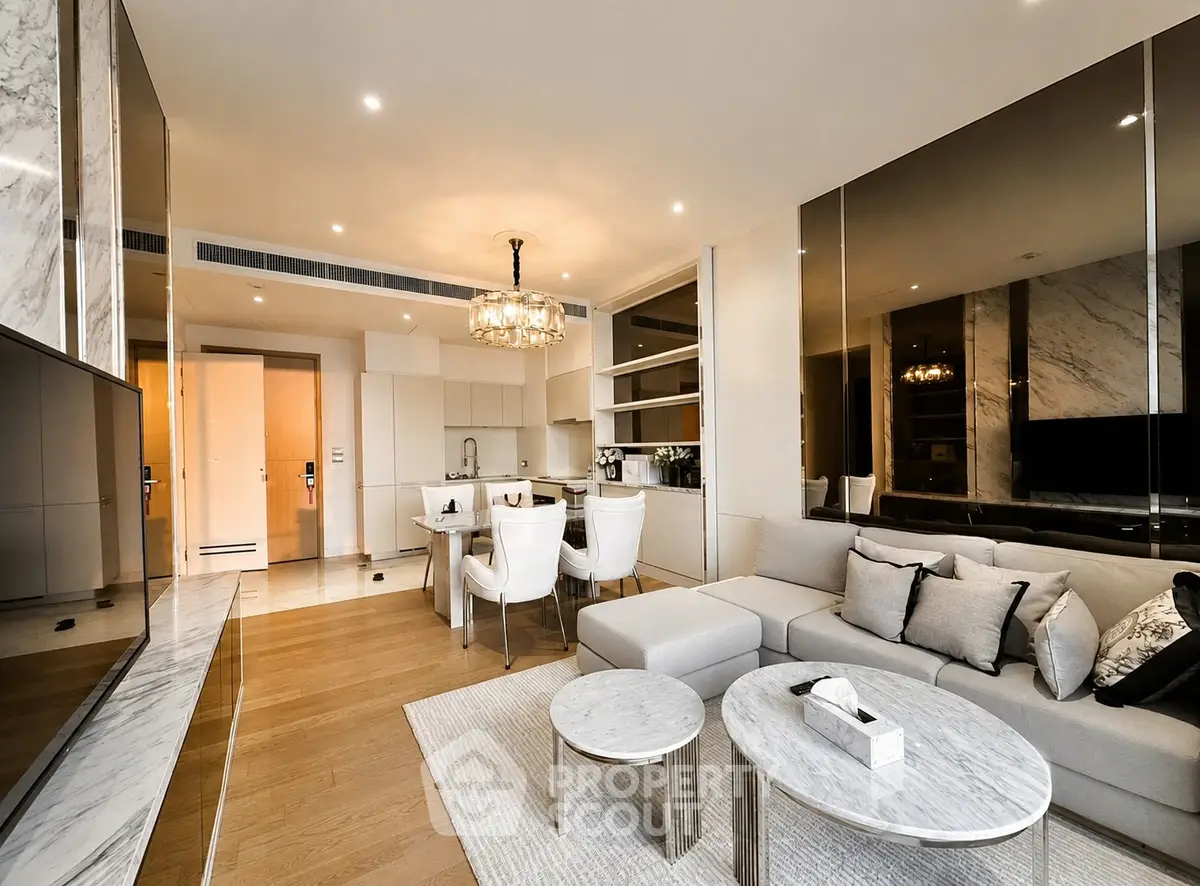 Luxurious modern living room with open kitchen, elegant decor, and stylish furniture in a high-end apartment.