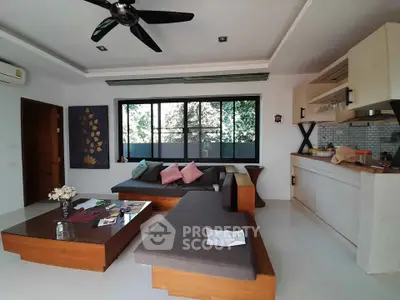 Modern living room with stylish furniture and open kitchen layout