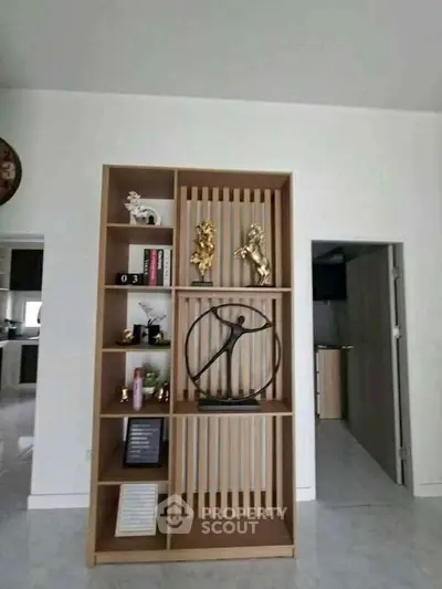 Modern interior with stylish shelving and decorative art pieces in a contemporary home.