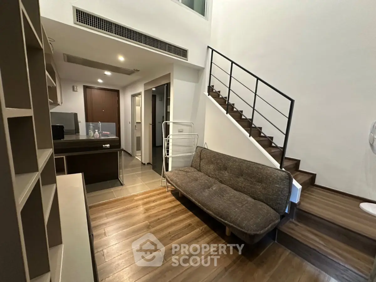 Modern duplex living room with stylish staircase and cozy seating area
