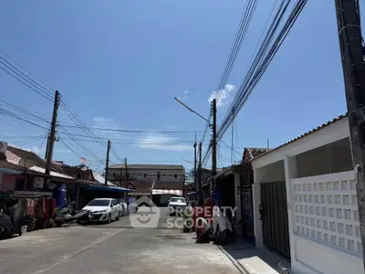 Charming residential street with traditional houses and clear blue sky, perfect for serene living.