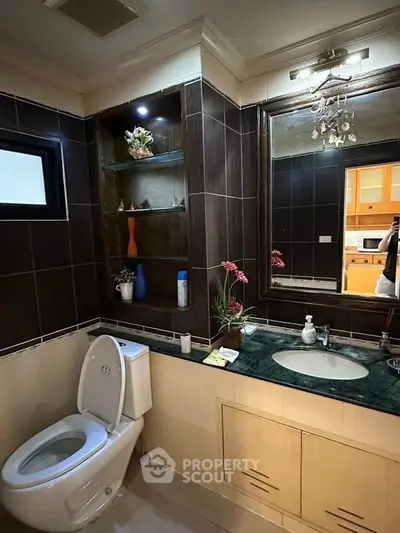 Modern bathroom with elegant fixtures and decorative shelving