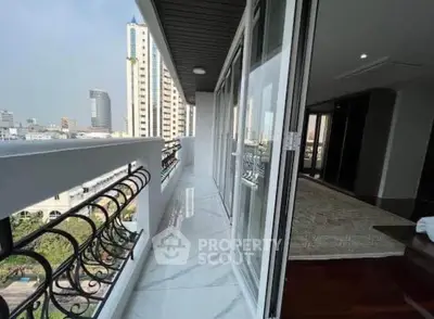 Spacious balcony with city view in modern high-rise apartment