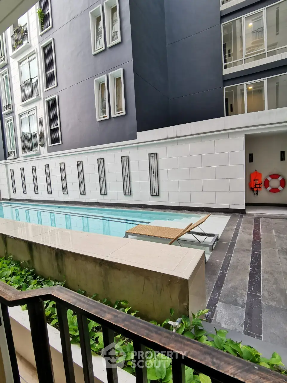 Modern apartment building with sleek pool and stylish exterior design.