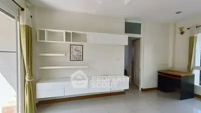 Spacious modern living room with sleek white cabinetry and natural light