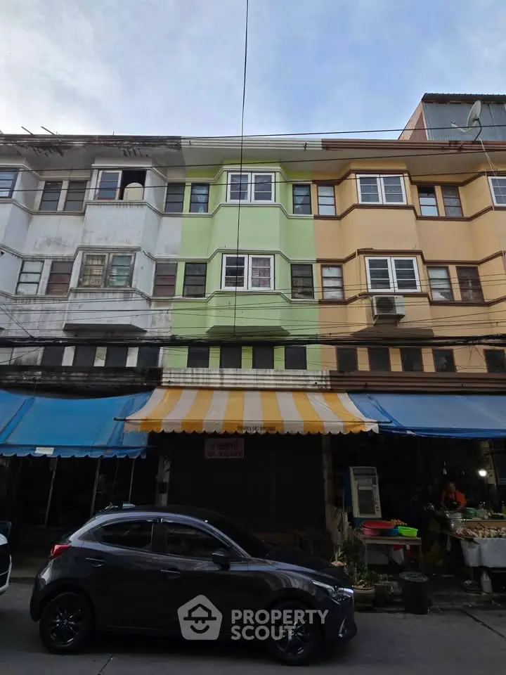 Charming urban building facade with colorful exterior and street view.