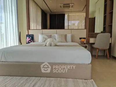 Luxurious bedroom with elegant decor and large windows for natural light.