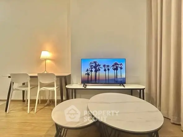 Modern living room with stylish furniture and ambient lighting, featuring a sleek TV setup and elegant decor.