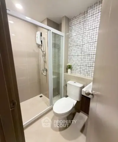 Modern bathroom with glass shower enclosure and stylish tile design
