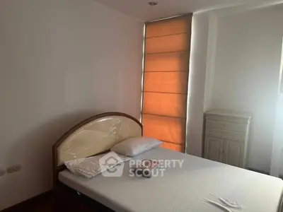 Cozy bedroom with natural light and modern furnishings, perfect for relaxation and comfort.