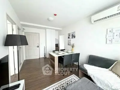 Modern living room with dining area, sleek furniture, and bright natural lighting.