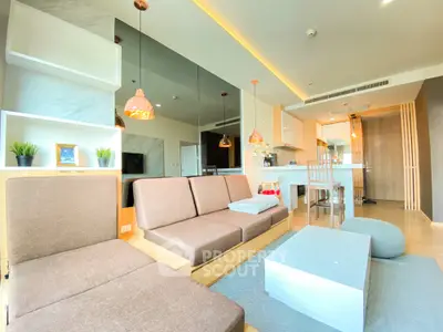 Modern open-plan living room with stylish decor and kitchen area