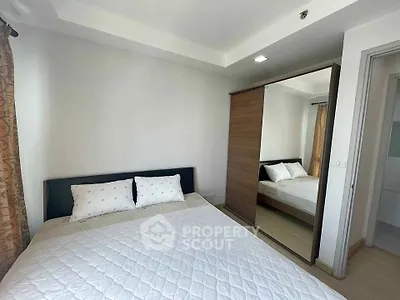 Modern bedroom with mirrored wardrobe and cozy bedding in a bright apartment