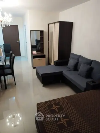 Spacious living room with modern furniture and elegant decor in a cozy apartment.