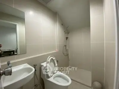 Modern minimalist bathroom with sleek fixtures and neutral tiles