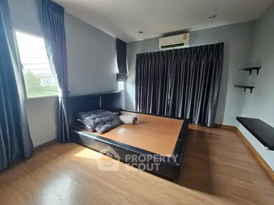 Spacious bedroom with modern design and large window for natural light