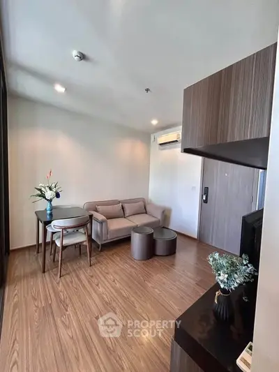 Modern living room with cozy sofa, stylish furniture, and elegant decor in a contemporary apartment.