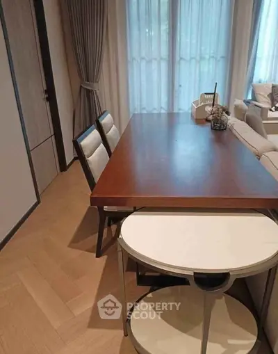 Modern dining area with elegant wooden table and stylish chairs in a cozy apartment setting.