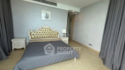 Luxurious bedroom with elegant decor and plush bedding in modern apartment.