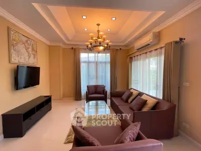 Elegant living room with modern chandelier and cozy seating area