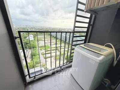 High-rise balcony with washing machine and panoramic city view, perfect for urban living.