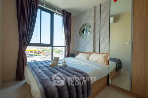 Modern bedroom with large window and stylish decor