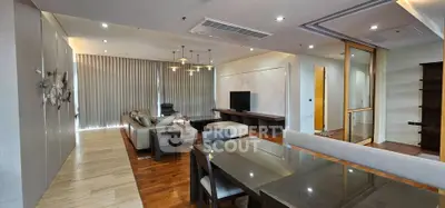 Spacious modern living room with elegant decor and open layout, featuring stylish furniture and ambient lighting.