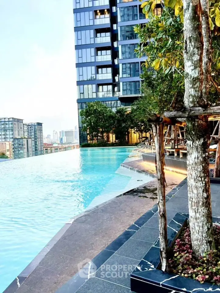 Luxurious high-rise building with stunning infinity pool and city view.