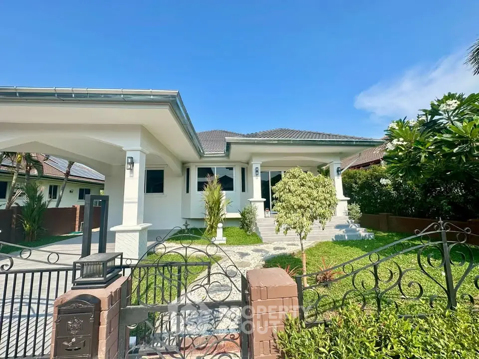 Charming single-story home with lush garden and elegant entrance in a serene neighborhood.